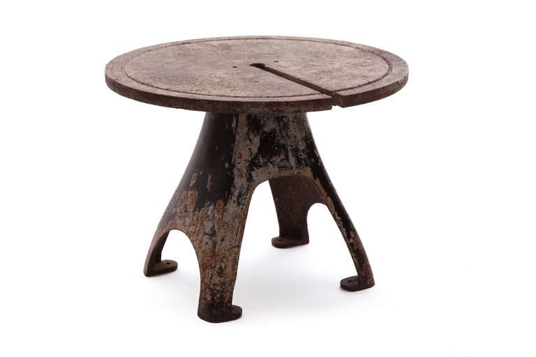 Monumental Industrial side table circa early 1900s. This incredible all original example is perfectly patinated and perfectly sculptural. Please note that it does weigh approximately 200 pounds as it is solid iron.