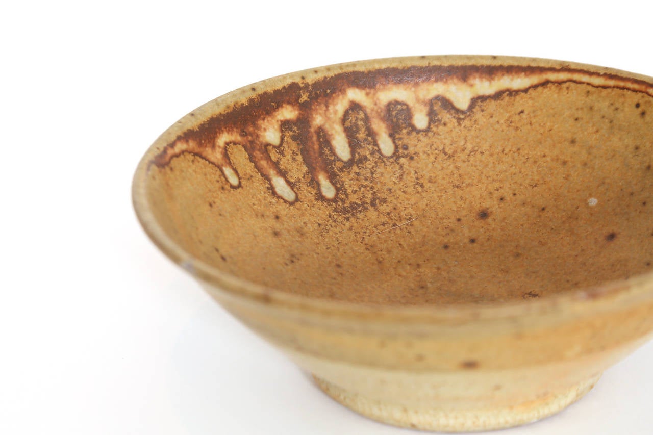 Warren MacKenzie ceramic bowls circa mid-1970s. The vessels have a thin clay body, footed base and unusual glazing. Price listed is for the set of two.