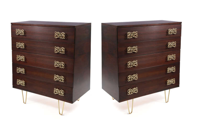 Pair of walnut and brass highboy chests of drawers, circa late 1950s. These five-drawer examples have sculptural scraffito brass drawer pulls and hand rubbed brass hairpin legs. The walnut cases have tapered sides and have been impeccably
