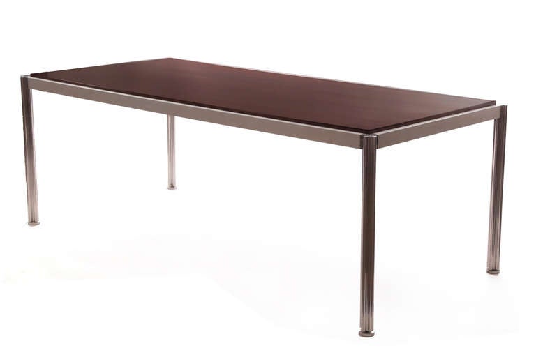 Rare walnut and aluminum dining table by Jens Risom, circa late 1960s. This superb example has an aluminum frame with shamrock shaped inset legs. The top is beautifully grained dark walnut. Can be used as a desk as well.