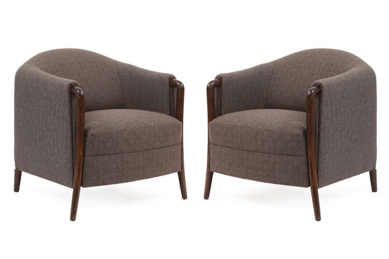 Sculptural lounge chairs by Walter Knoll, circa late 1960s. These examples have elegant frames juxtaposed with subtly curved oak legs. They have recently been upholstered in a stunning charcoal gray tweed. Price is for the pair.