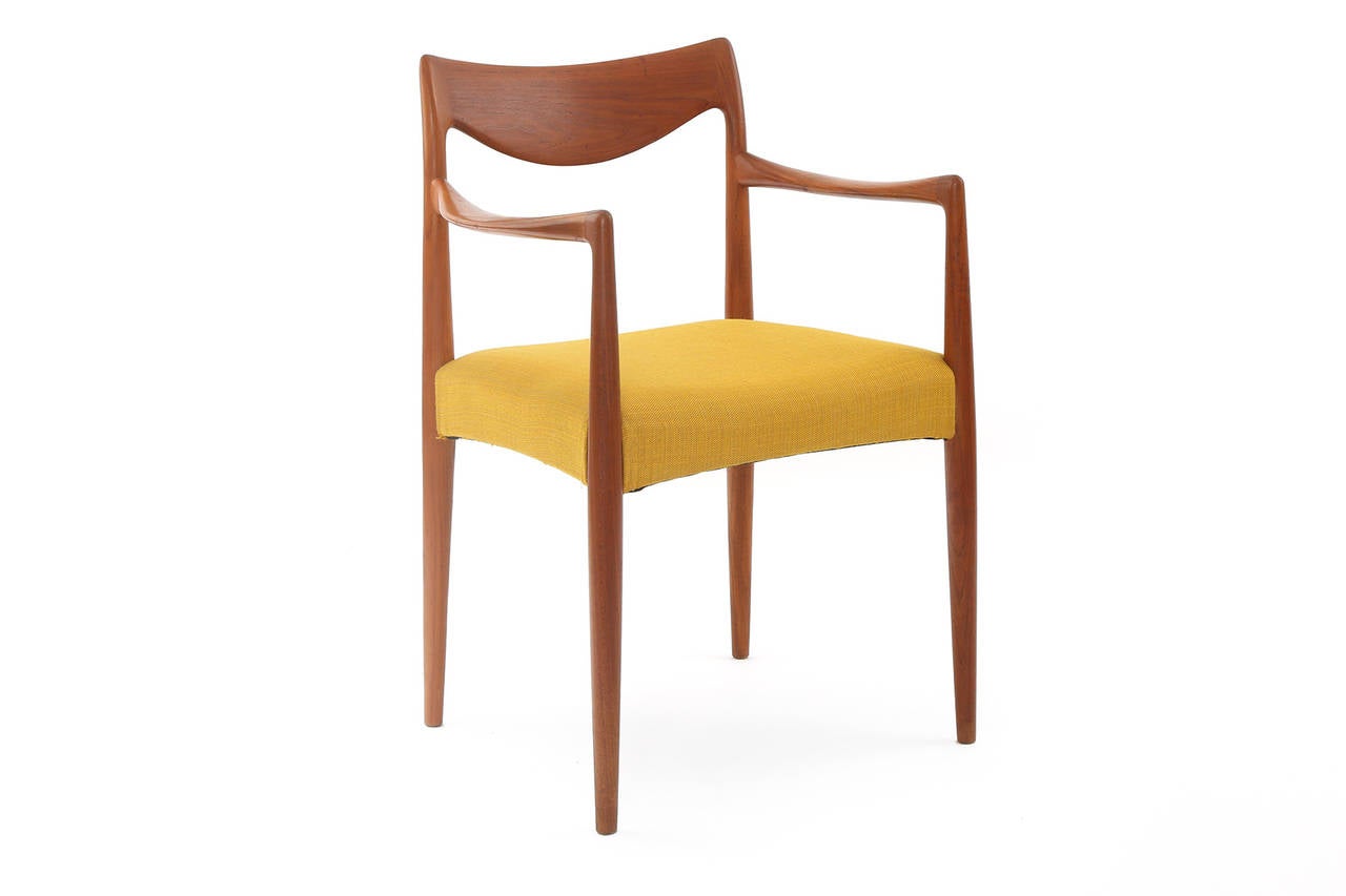 Set of eight Rastad and Relling sculpted teak dining chairs, circa late 1950s. These stunning examples are upholstered in their original mustard upholstery. All joints at wright on these and they have been newly oiled. Price listed is for the set of