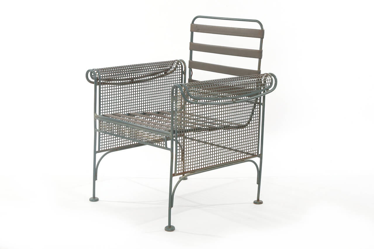 Four sculptural metal patio chairs, circa late 1960s. These examples have perforated metal sides and subtly curved arms. They can be used indoors or out and are ready for the cushions of your choice. Price listed is for the set of four. These can be