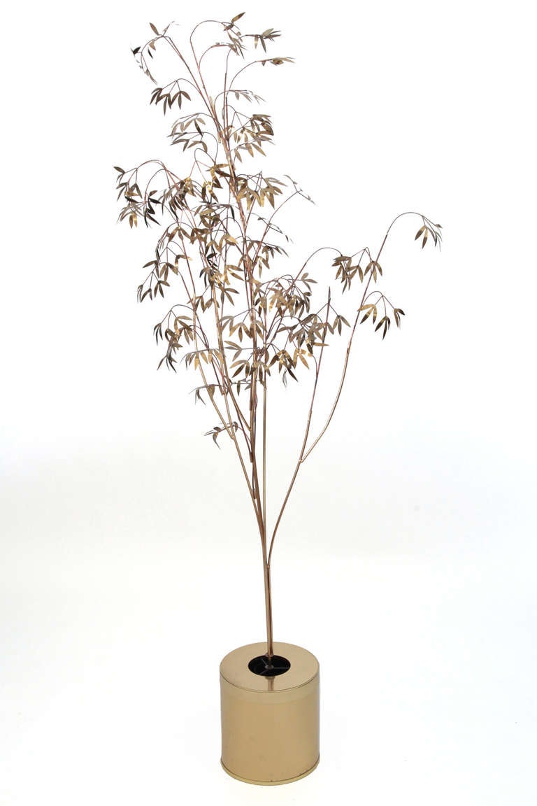 Curtis Jere tree sculpture and lamp, circa early 1970s. This phenomenal example has a brass planter base that illuminates and a large scale brass tree with hand forged leaves within. Diameter of planter 11