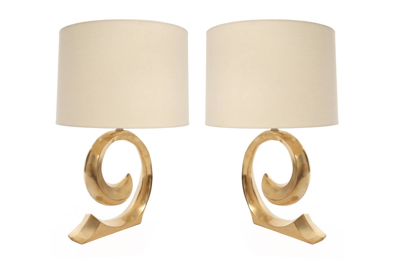 Elegant pair of Pierre Cardin satin finished brass lamps, circa early 1970s. These examples have sculptural solid brass forms and are priced as a pair without shades. If shades are needed we can help as well. Measures: Shade shown is height 12