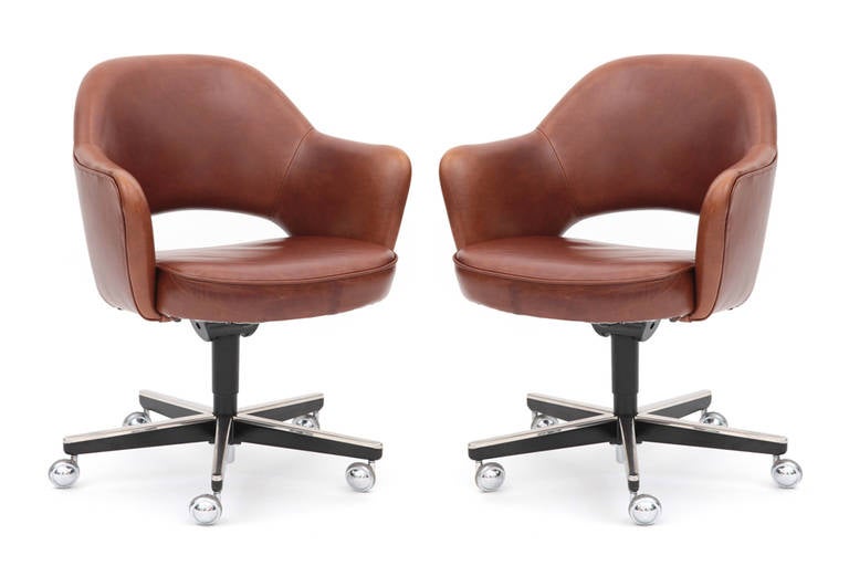 Pair of Eero Saarinen for Knoll executive office chairs. These examples have been newly upholstered in a lovely and supple toffee leather. They have chrome casters and retain their original Knoll decals. Price listed is for the pair.