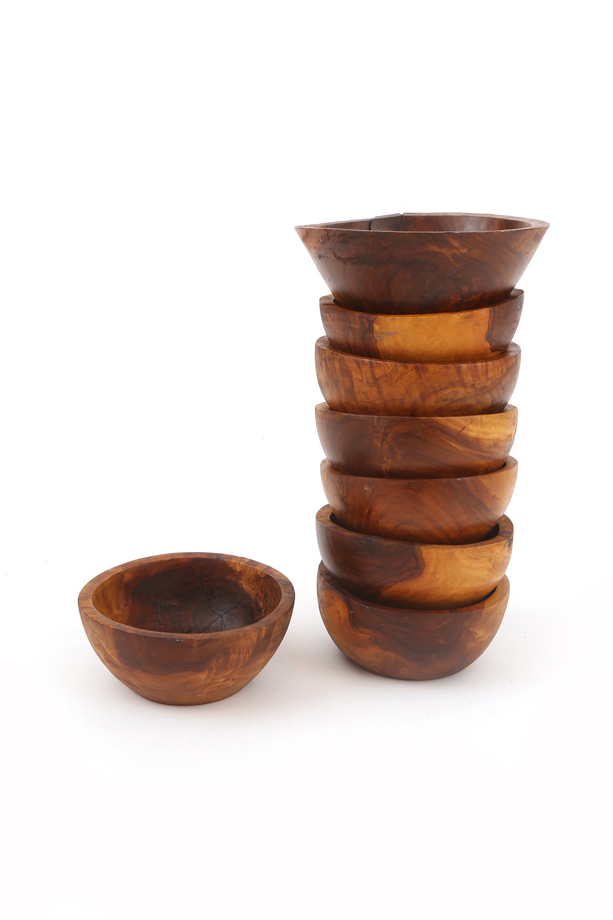 Eight stunning hand-turned olive wood bowls. Each of these examples has profound graining and variance in color. There is one slightly larger example that measures 8.63