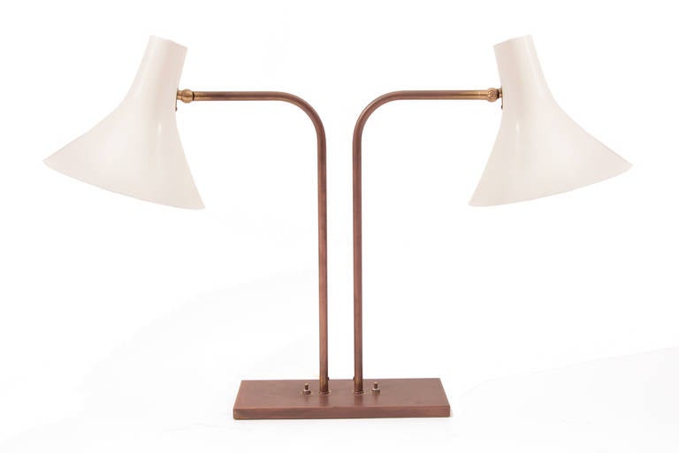 Rare Greta Von Nessen for Nessen Studios double cone table lamp circa mid-1950s. This seldom seen all original example has a bronze base with bronze arms and adjustable features. The cones are enameled metal and in excellent condition. They can be