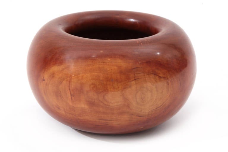 Rare and early Ed Moulthrop wild cherry turned bowl. This example dates from the 1970s and has incredibly varied tones in the cherry. It does have a split on one side that appears to be a natural part of the wood. This bowl has the early 