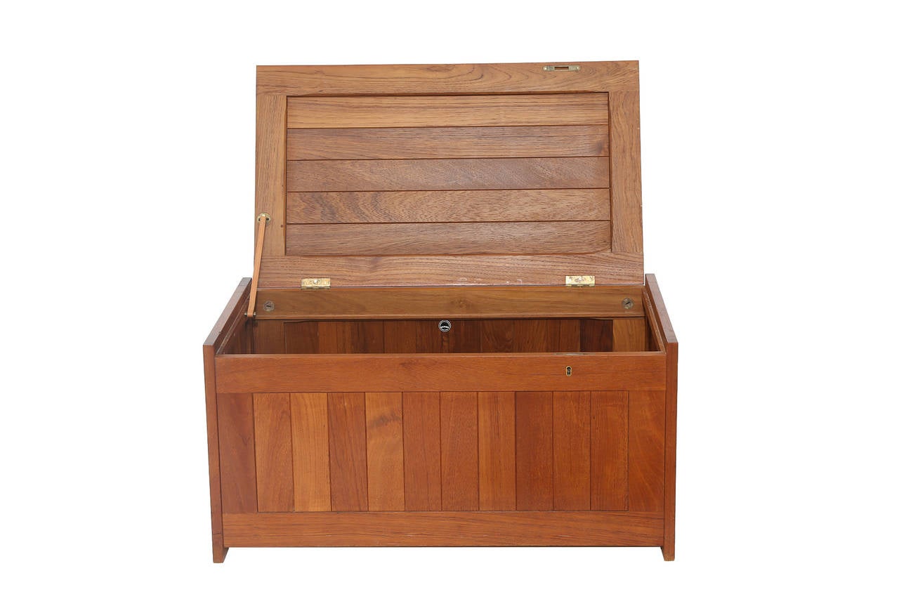 Illums Bolighus solid teak blanket chest, circa late 1950s. This all original example has a solid teak slatted top and sides, patinated brass hinges and interior leather strap.