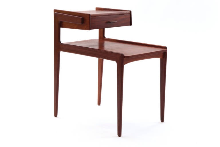 Pair of teak nightstands by Kai Kristiansen circa late 1950s. These lovely petite examples have floating cantilevered tops with one drawer and sculpted teak handle. Price listed is for the pair.