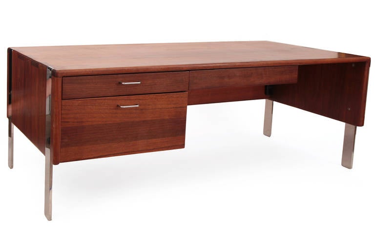 Rare and stunning solid sedua and steel desk by Gerald McCabe, circa early 1970s. This example was custom built for a home in the Santa Barbara area and features inset solid steel legs and incredibly grained solid sedua wood. Both sides of the desk