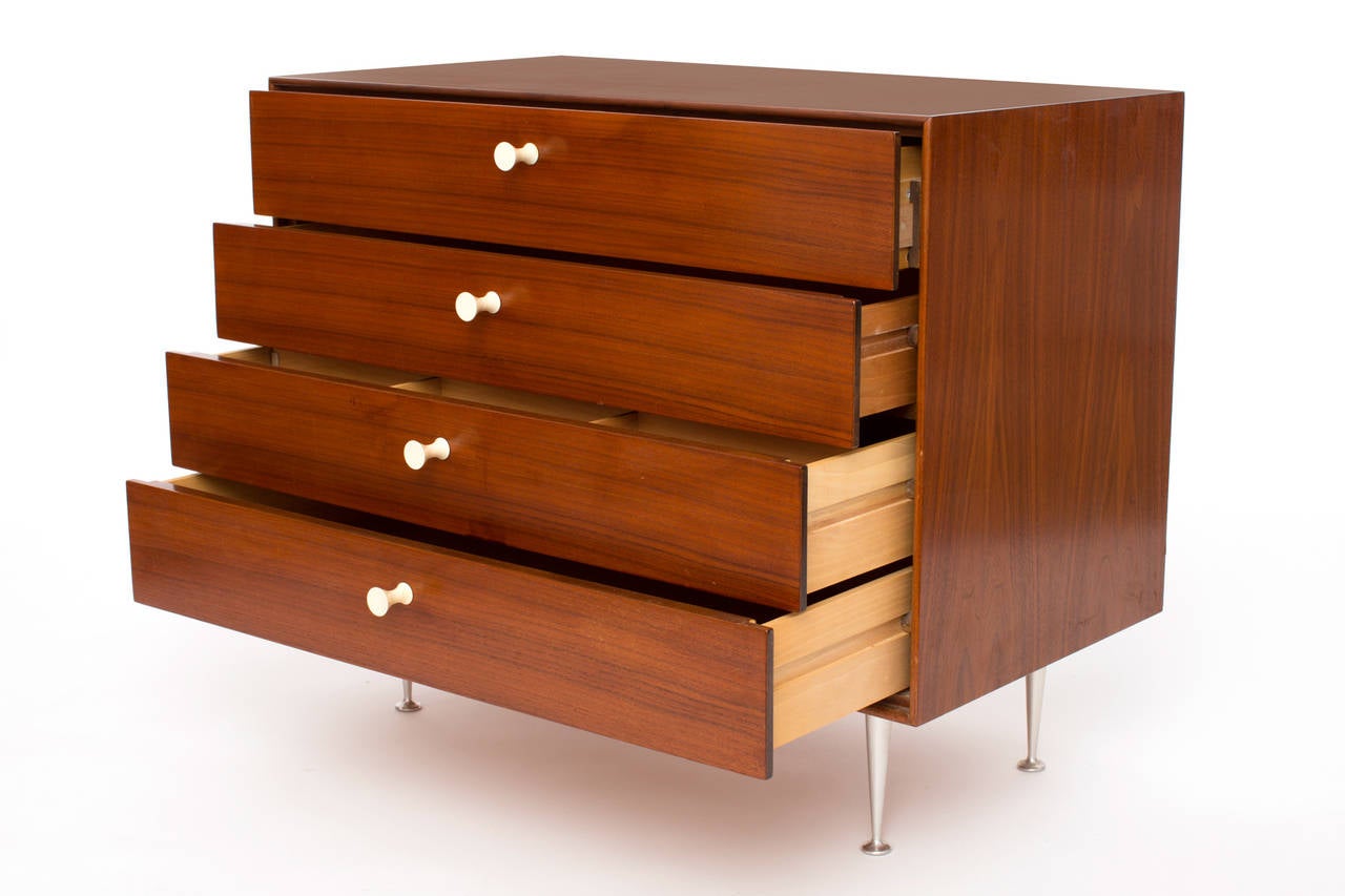 Rare George Nelson for Herman Miller thin edge chest, circa late 1950s. This all original example has a beautifully grained walnut case and drawer fronts, porcelain hour glass pulls and iconic tapered steel legs. The top drawer of this chest has a
