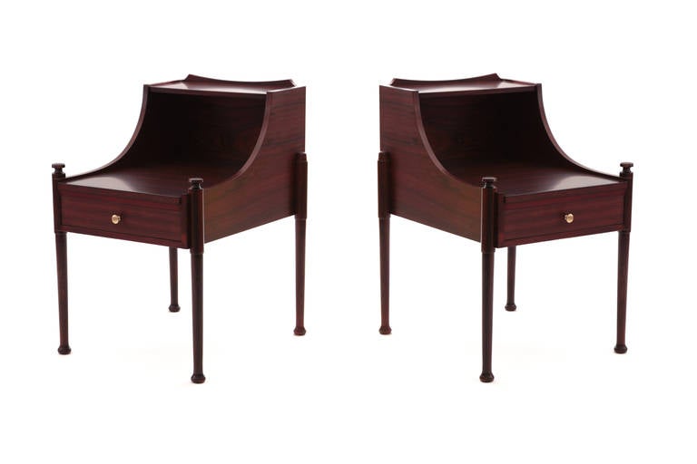 Stunning pair of rosewood and brass nightstands from Denmark, circa mid-1960s. These all original examples have stunning graining to the rosewood and have finished backs. They each have one-drawer, brass drawer pulls and sculptural forms. Price