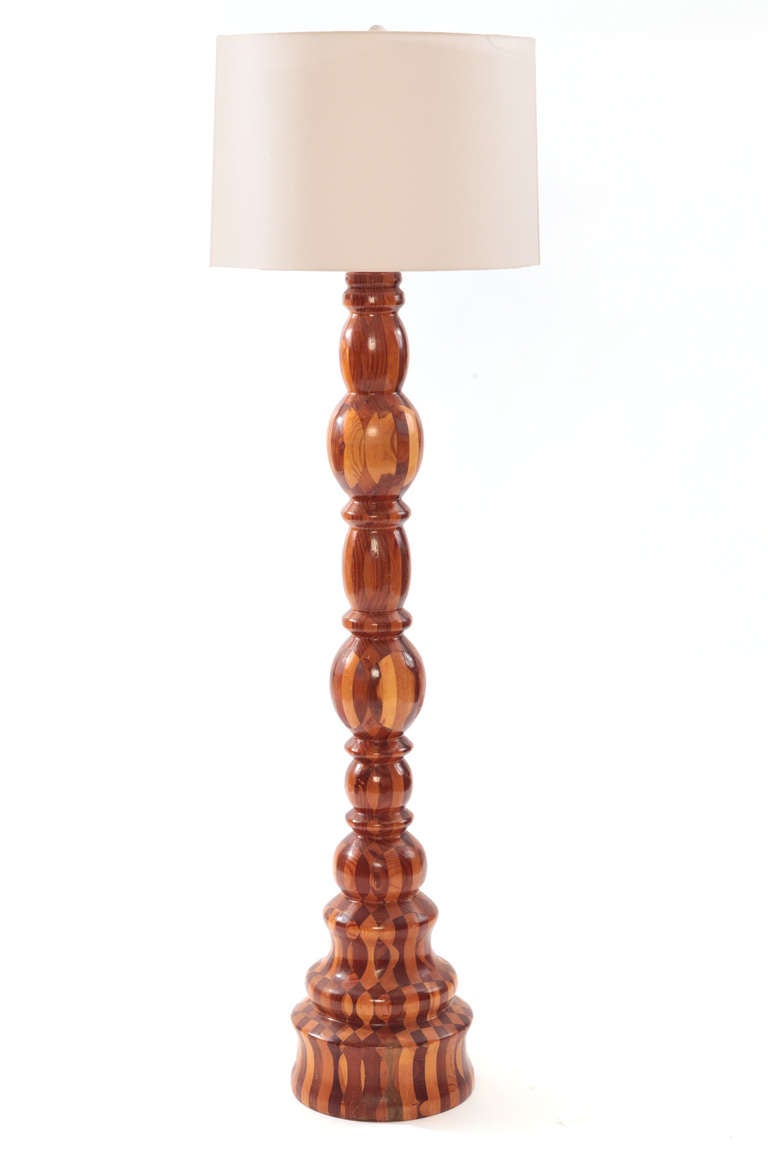 Monumental hand-turned wood floor lamp, circa early 1970s. This large-scale example incorporates four different species of wood into an elegant sculptural floor lamp.