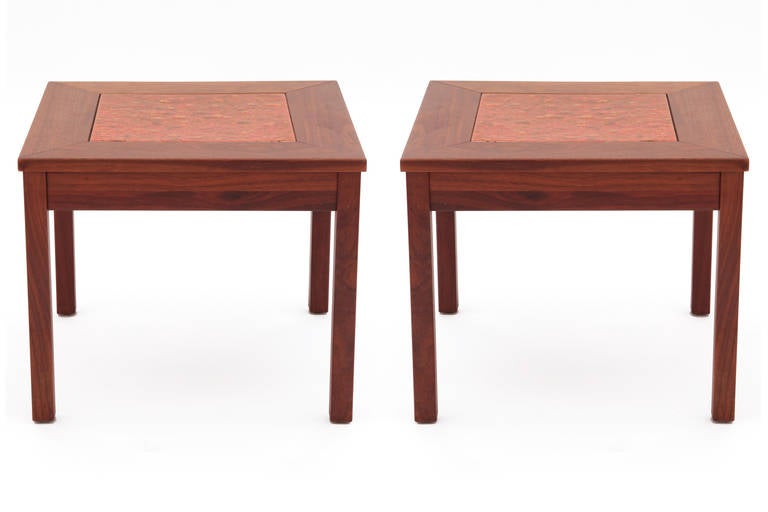 Pair of Brown Saltman walnut and enameled metal side tables. These all original examples have solid walnut legs and tops with inset persimmon yellow and taupe enamel tops. Price listed is for the pair.