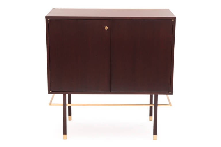 Rare Harvey Probber flip top bar circa mid 1950's. This stunning example has a striped African mahogany case and legs with elegant hand rubbed brass accents. The interior top and drawer fronts are white. This has recently been impeccably restored.