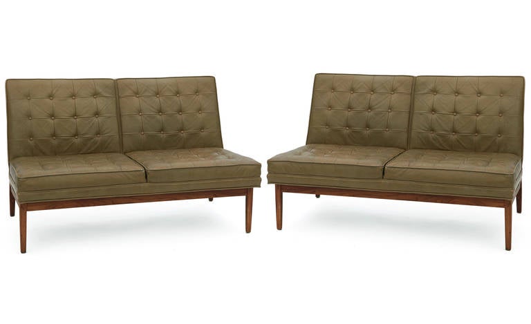 Pair of Jens Risom for Knoll button tufted leather sofas, circa late 1950s. These examples are upholstered in their original perfectly patinated leather and have nicely grained solid walnut flat bar frames. Foam has been replaced. These can be put