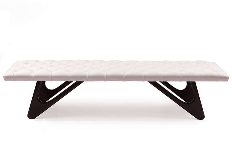Snow white leather and mahogany bench, circa mid-1960s. This sculptural example has newly finished solid mahogany hair pin legs and has been newly upholstered in a supple diamond tufted white leather.