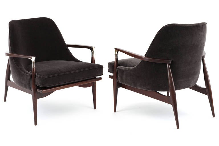 Sculptural pair of lounge chairs by Ib Kofod-Larsen circa late 1950's. 
These examples have newly finished beautifully grained solid manogany frames. They have been newly upholstered in a supple and stunning charcoal velvet mohair. Price listed is