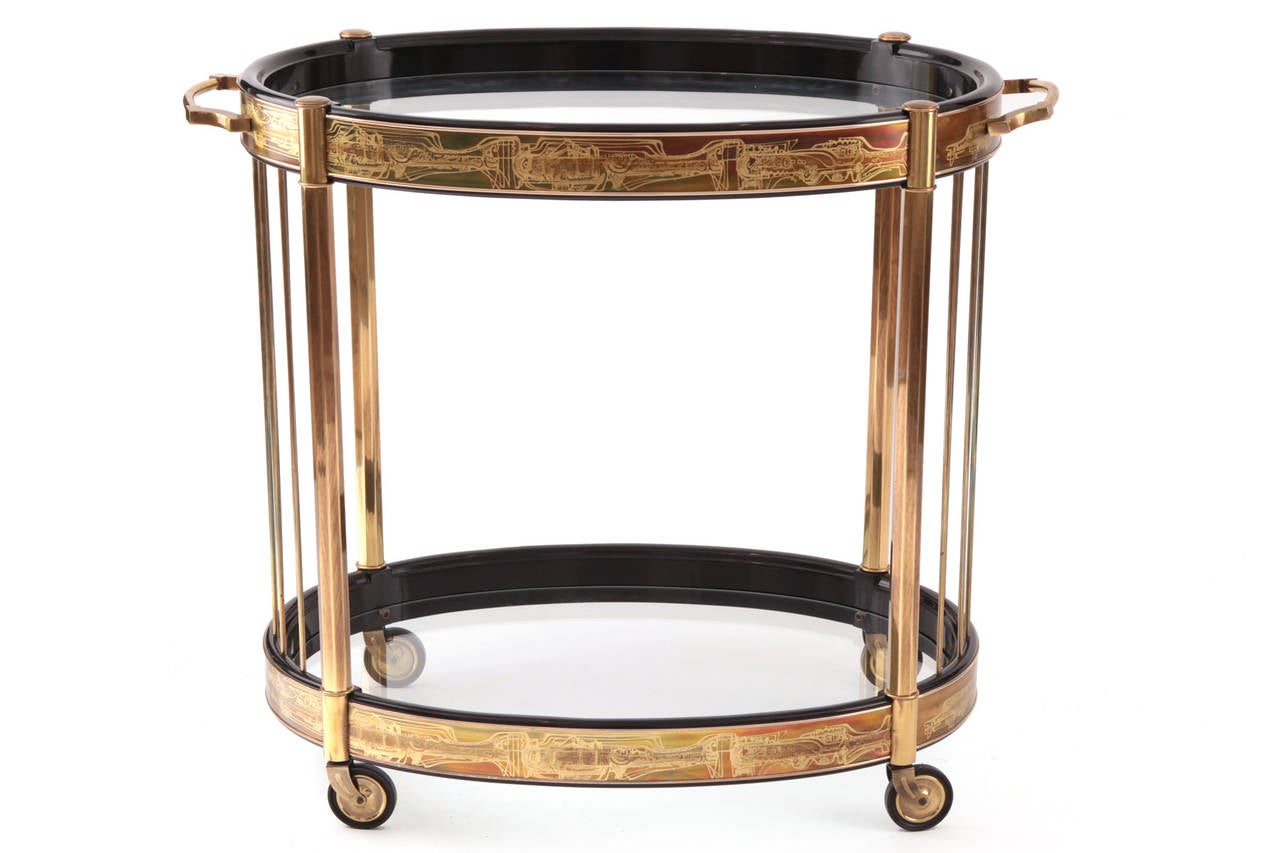 Bernard Rohne for Mastercraft bar cart circa late 1960's. This all original example has Rohne's signature etched brass detailing ebonized wood frame and inset two tiered glass. Excellent original condition. Please see our other listings for other