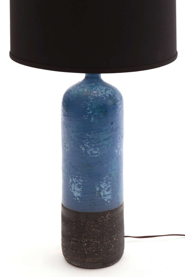 Lovely Raymor ceramic table lamps, circa late 1950s. This example has a elongated cylindrical ceramic body with blue and black glazing. Price does not include shade.