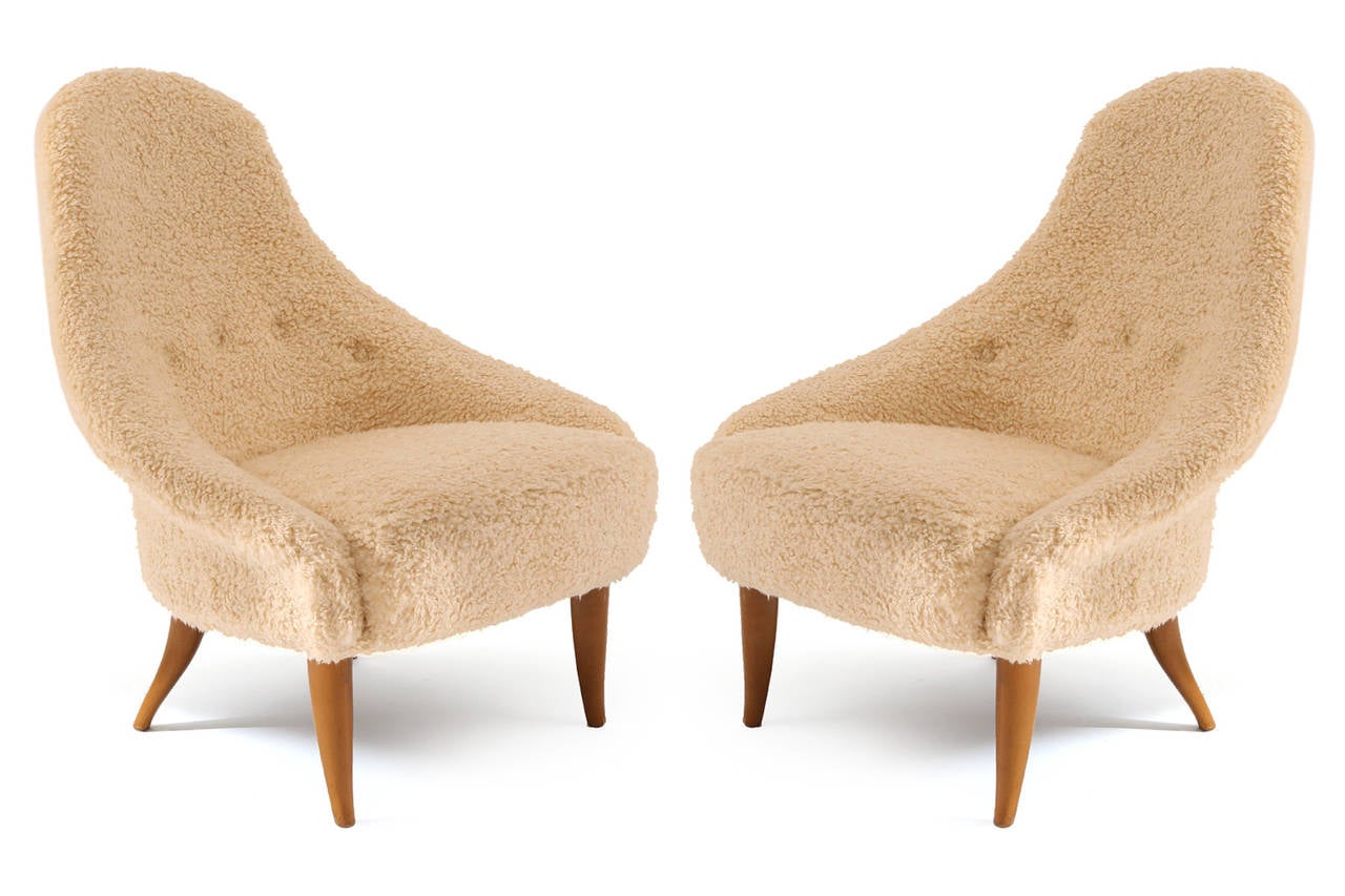 Sculptural pair of lounge chairs by Kerstin Hörlin-Holmquist from 1965. These phenomenal examples have been newly upholstered in a cream sheepskin upholstery. The legs are solid tapered beech wood. Price listed is for the pair.
Measure: Seat