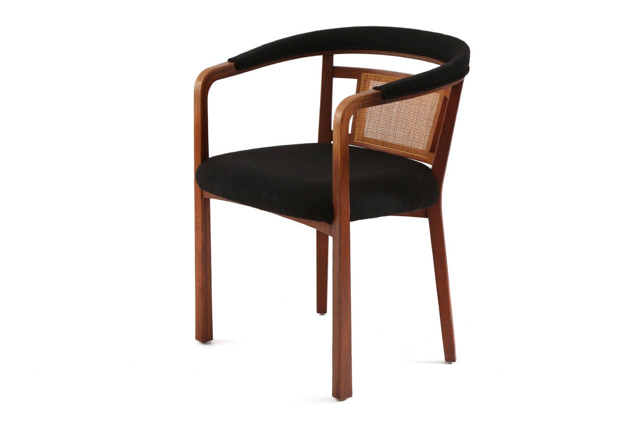 Pair of Edward Wormley for Dunbar occasional chairs, circa early 1960s. These examples have subtly curved and tapered walnut frames with inset wicker backs and heathered bouclé black upholstery. Price listed is for the pair.