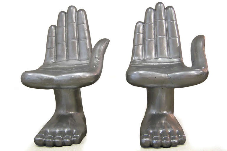 Pair of cast aluminum hand foot chairs or sculptures after Pedro Friedeberg. These iconic examples can be used indoors or out and look wonderful from every angle. Price listed is for the pair.