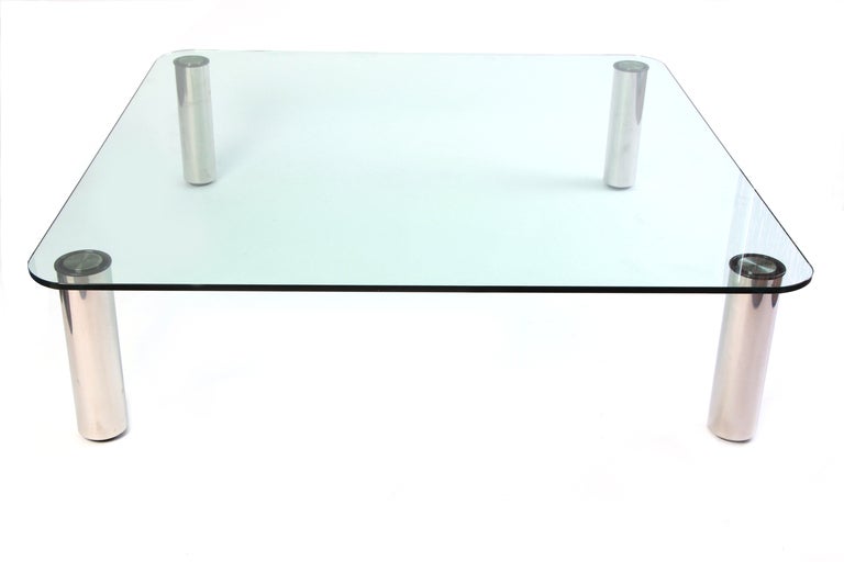 Massive Marco Zanuso polished stainless steel and glass cocktail table circa early 1970's. This nearly 5' square example employed a state of the art electronic welding process wherein the steel legs were invisibly welded to the glass top. Excellent