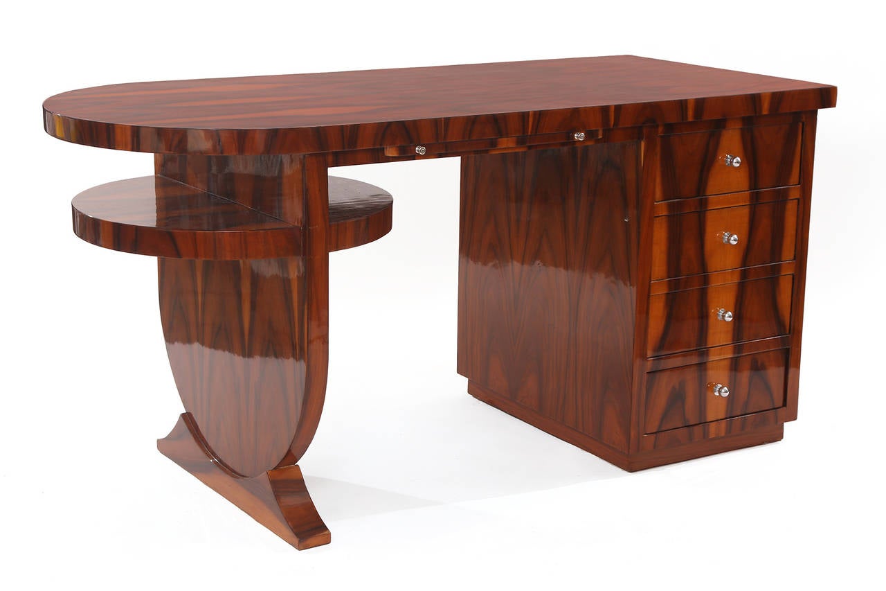 Flame grained rosewood Art Deco desk, circa early 1940s. This example has phenomenal blonde sap grain to the rosewood. It has four drawers a pull-out shelf and polished chrome pulls. The finish is a French polish so it is very high sheen. Finished