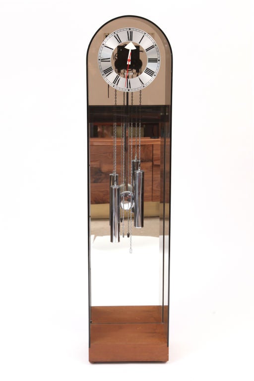 Arthur Umanoff for Howard Miller grandmother clock circa early 1970's. This example is model number 677 and is done in smoked lucite walnut and chrome. The movement is visible from the front and back and and the clock is in excellent original
