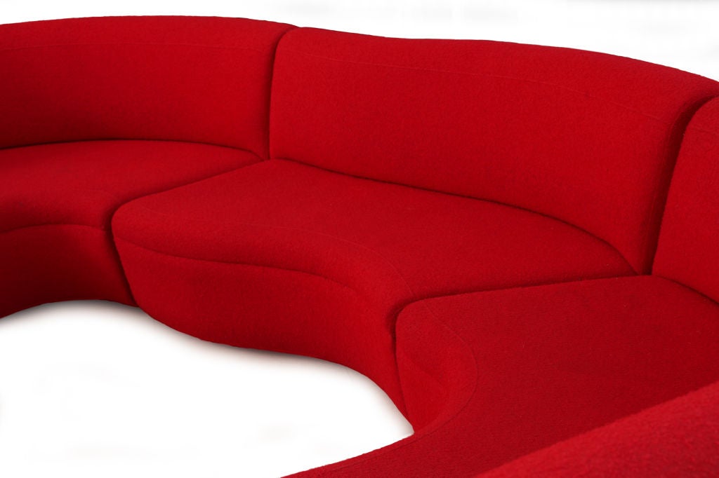 Whimsical sculptural and multi functional omni sofa by Karim Rashid. This sectional can be configured as a circle as individual pieces free floating and as a serpentine organic form. This example has its original red boucle upholstery. Red will
