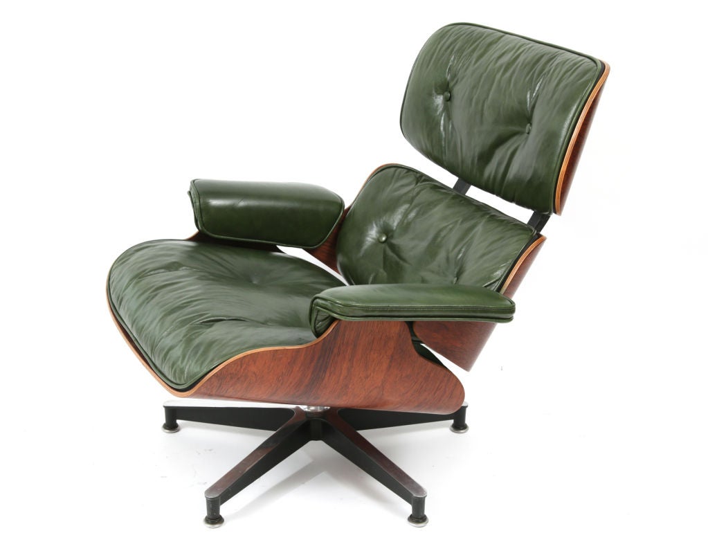 Rare Charles and Ray Eames for Herman Miller 670 lounge chair and ottoman circa early 1960's. This example was specially ordered in British racing green leather and is down filled. The rosewood shells are wonderfully grained and in excellent