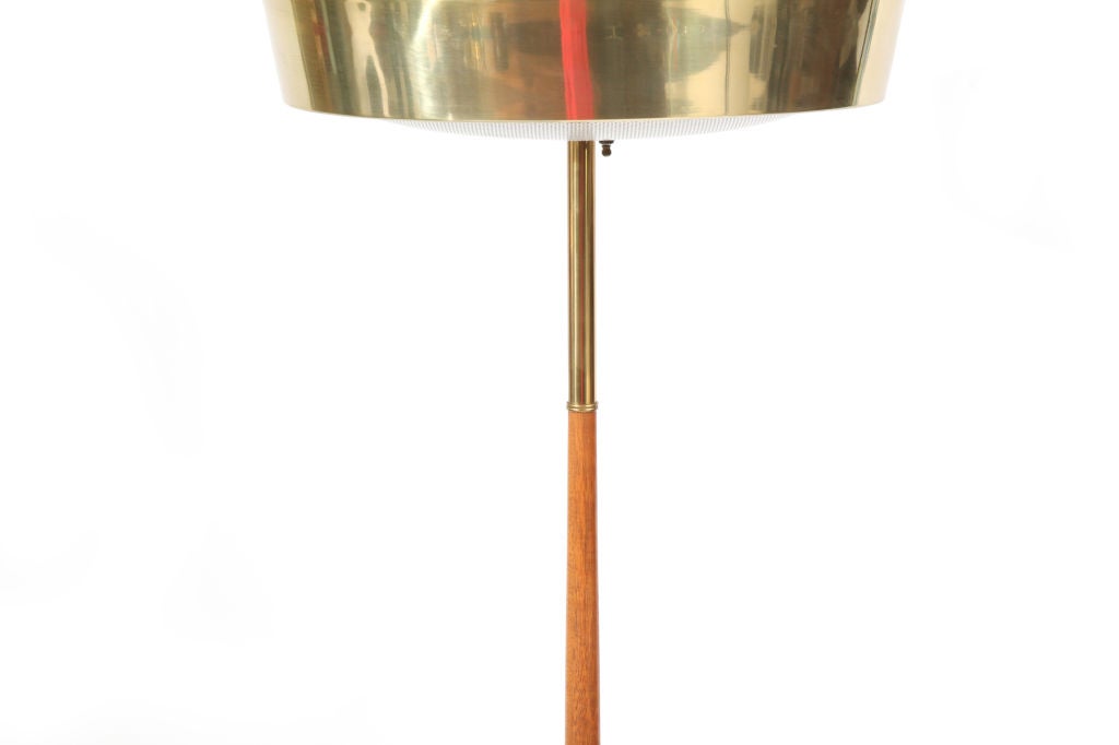 Brass mahogany and perforated metal floor lamp by Stiffel circa late 1950's. This all original example has a brass and mahogany pole satin brass trim round the shade and base and a perforated metal light cover.