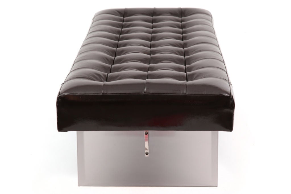 Lucite stainless steel and leather bench circa early 1970's. This example has two thick lucite squares with a solid stainless steel stretcher and is tufted in a glossy black leather.