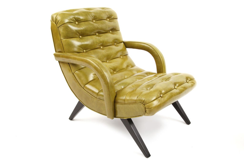 Caterpillar lounge chair and ottoman circa late 1950's. This undulating example has splayed ebonized walnut legs subtly curved arms and has been newly upholstered in a supple avocado leather. Excellent restored condition. Price is for the chair and