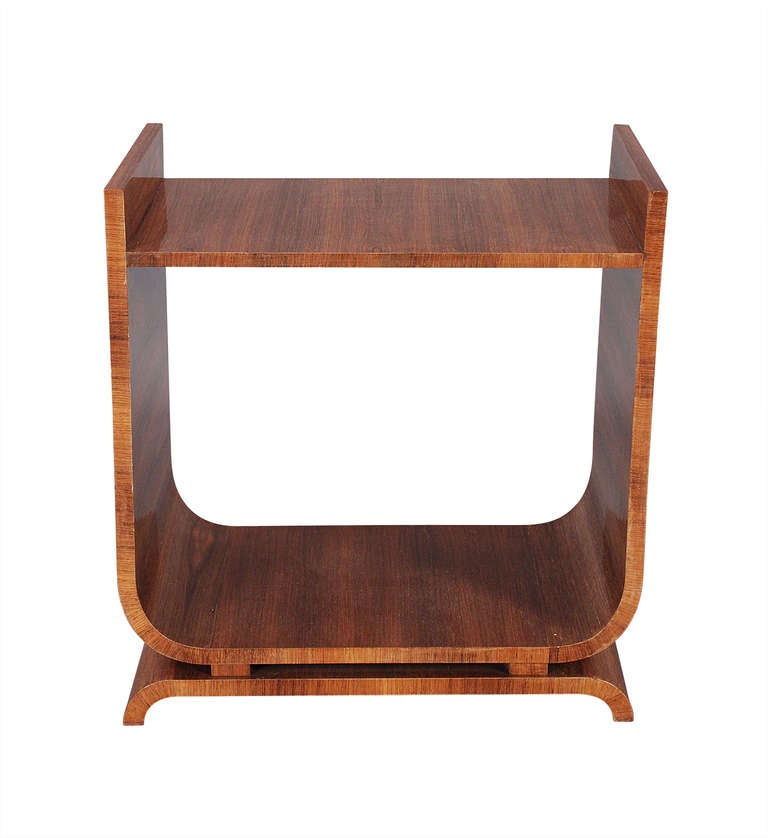 An Art Deco period, rosewood veneered occasional table of U-shape . The low shelf below is ideal for displaying sculpture, a piece of ceramic, or a planter. Attributed to the DeCoene Freres.