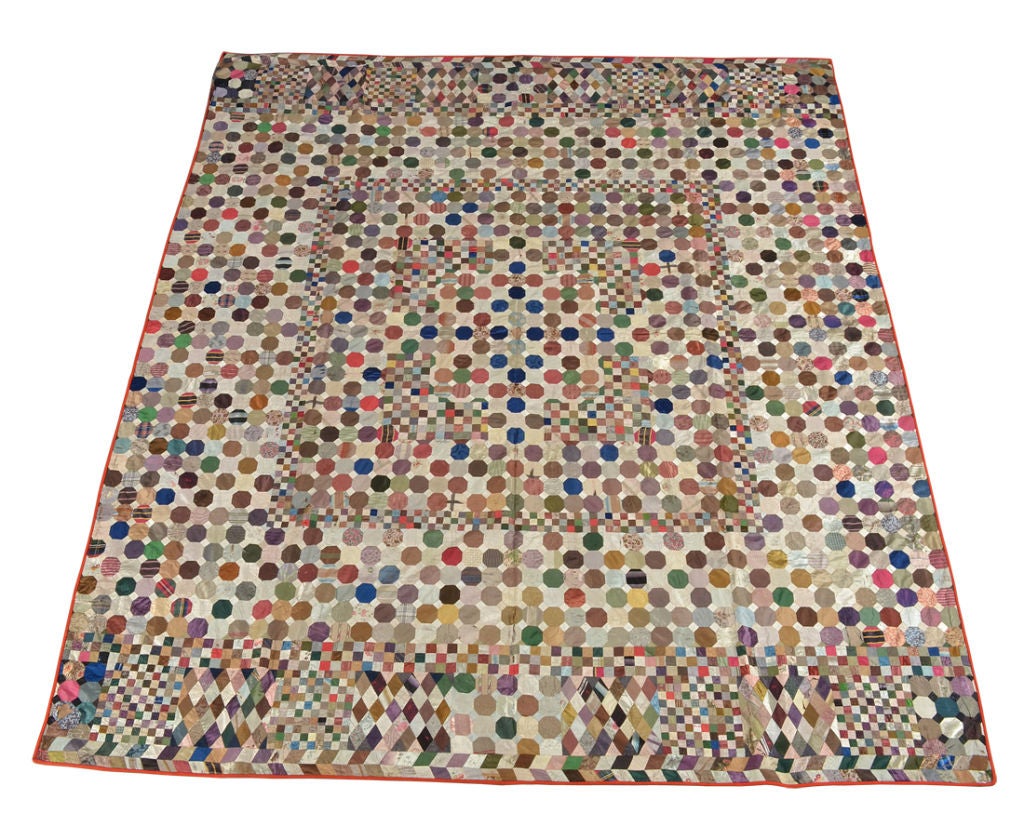 An English quilt composed of octagonal, square, and diamond-shaped silk patches.