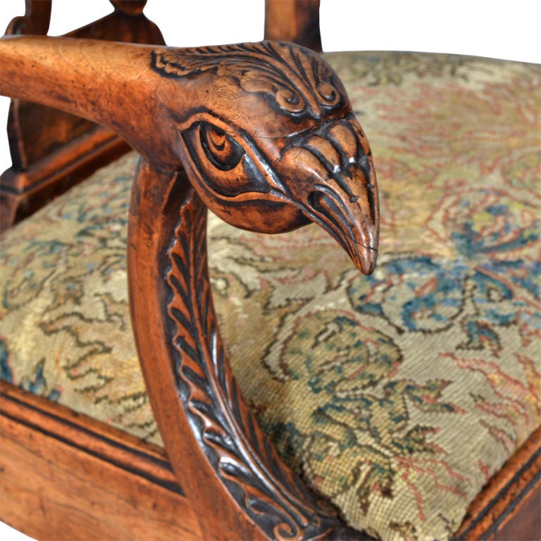 A highly carved fruitwood armchair. Excellent quality carving throughout including a florette on the crest rail, eagles’ heads on the arms, and ball and claw feet. The drop-in seat covered in old needlework.