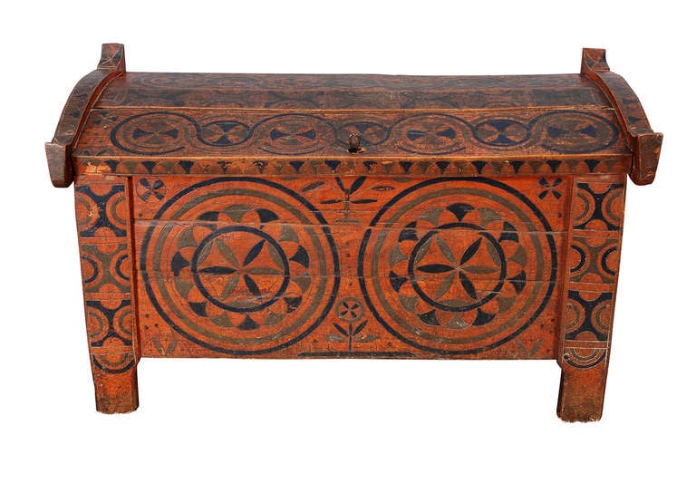 A coffer with peaked, hinged lid. Painted and incised with geometric decoration in red, green, and blue. Eastern European in origin. Possibly Slovakian or Romanian.
