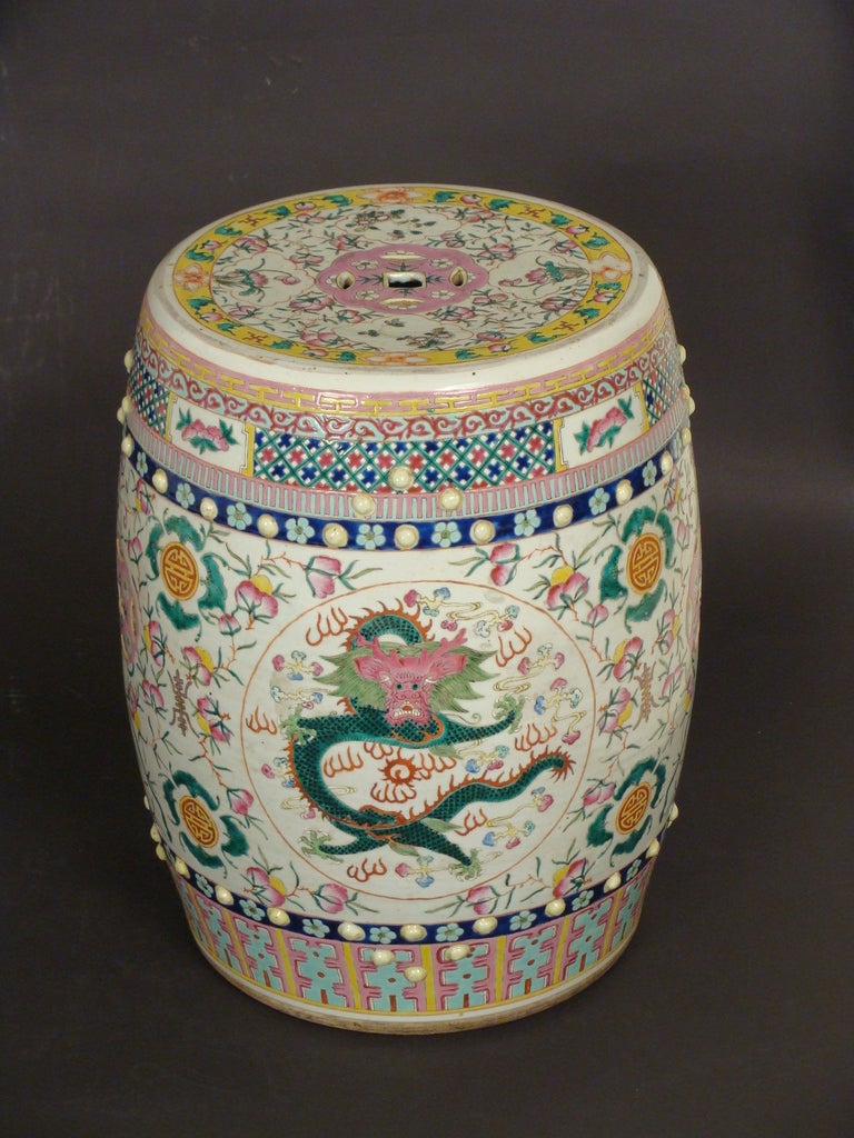 A very colorful Chinese polychrome decorated garden seat with dragon and floral design, circa 1920. 