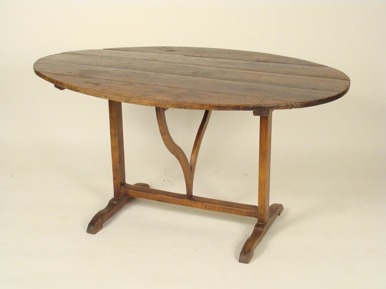 Antique French oval tilt top wine table, 19th century.