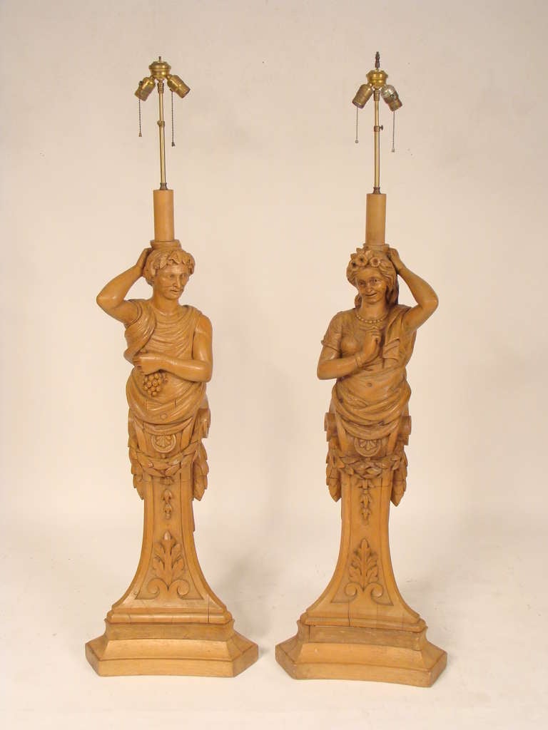 Pair of large carved figural table/floor lamps, late 19th century. These lamps could be used as either oversize table lamps or floor lamps. The height of the base and carved figures is 44