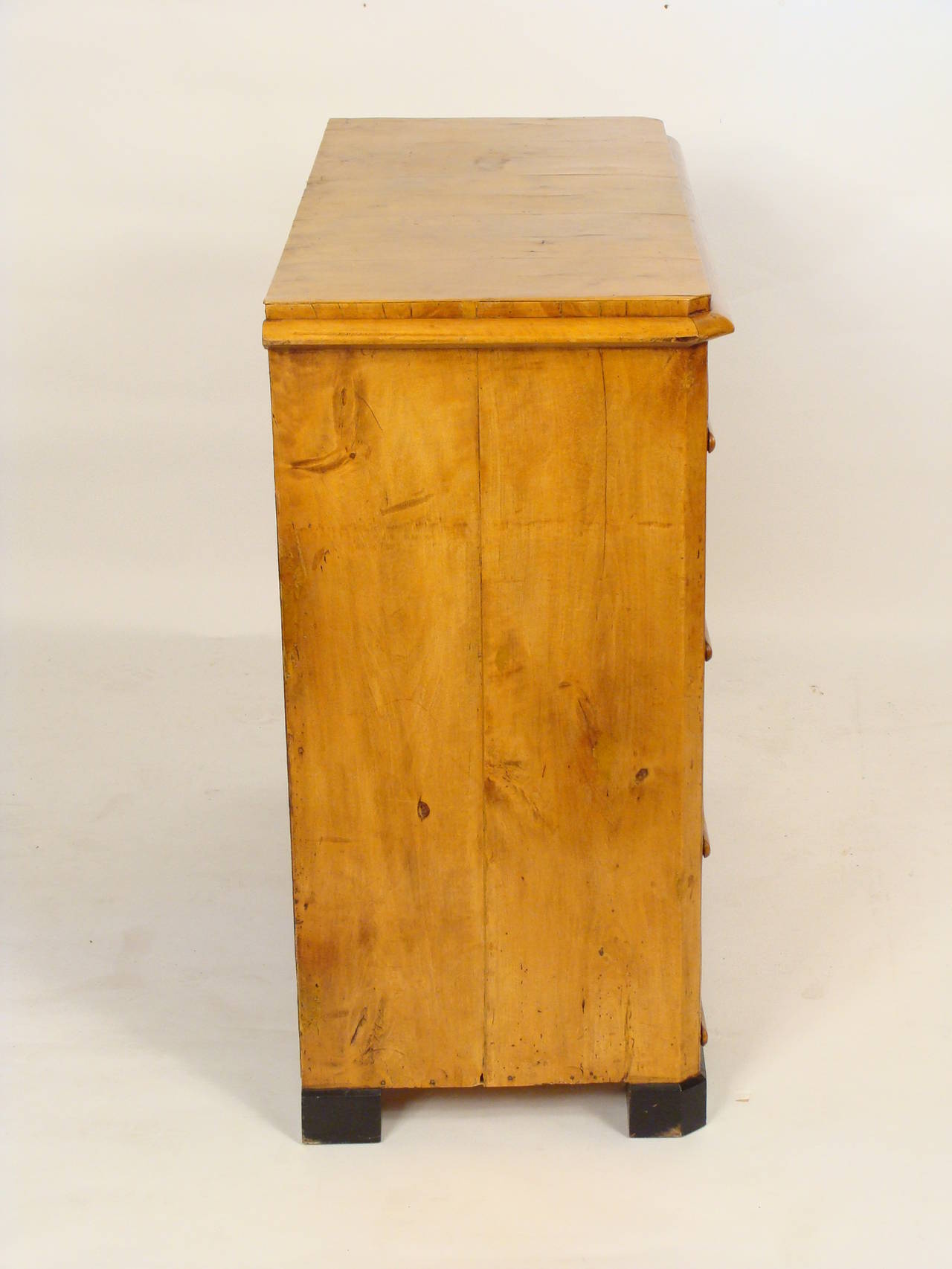 Biedermeier birch chest of drawers with bone escutcheons and ebonized feet, circa 1840.
