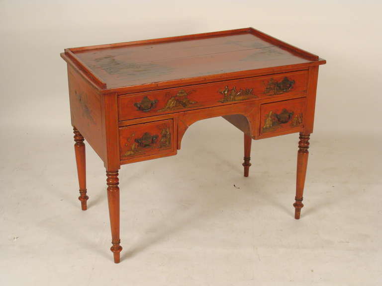 Red chinoiserie decorated writing table, 19th century. This writing table has nice raised chinoiserie decoration. The chinoiserie decoration is old but not original, it was  most likely was done in the early 20th century.