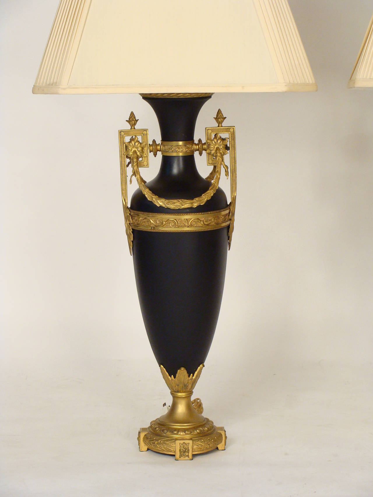 Pair of tole and gilt metal neoclassical style table lamps, circa 1960. Please note the height of the vases are 29