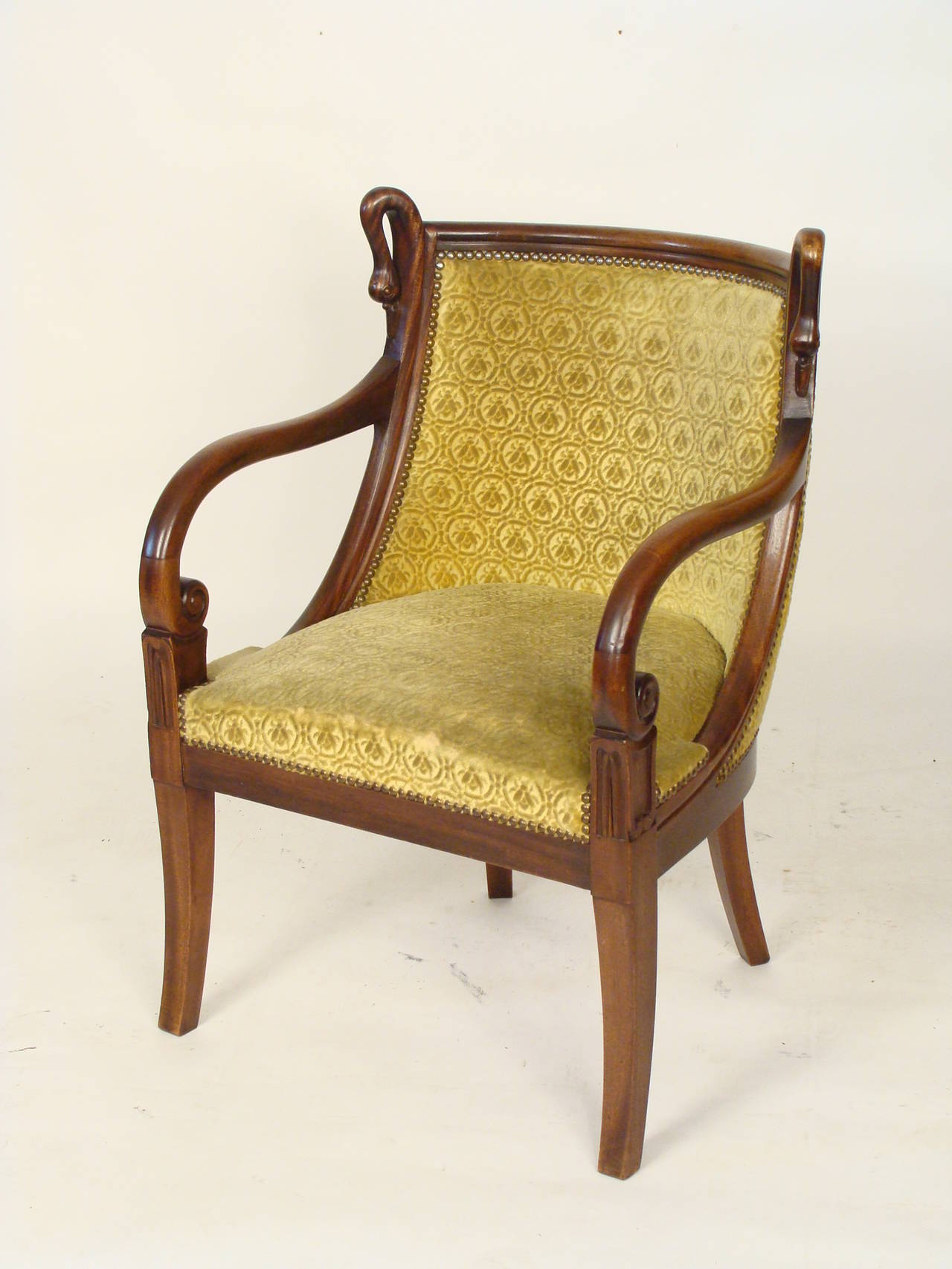 Pair of Directoire style carved mahogany armchairs, circa 1930. With a very comfortable barrel back and carved swans.