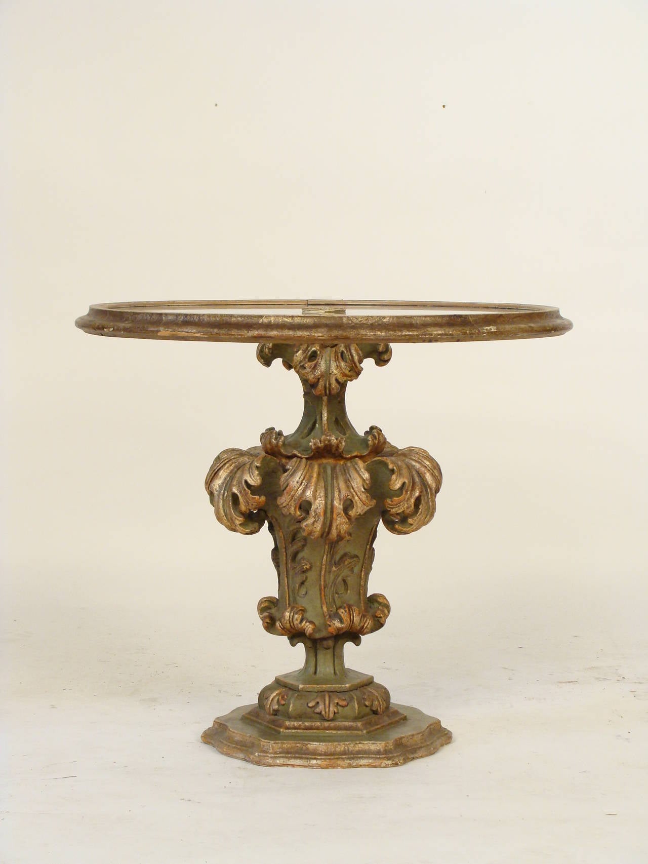 Italian painted wood and gesso glass top occasional table, mid-20th century. This is a very decorative, Vintage Italian Glass top occasional table with paint and silver leaf decoration.