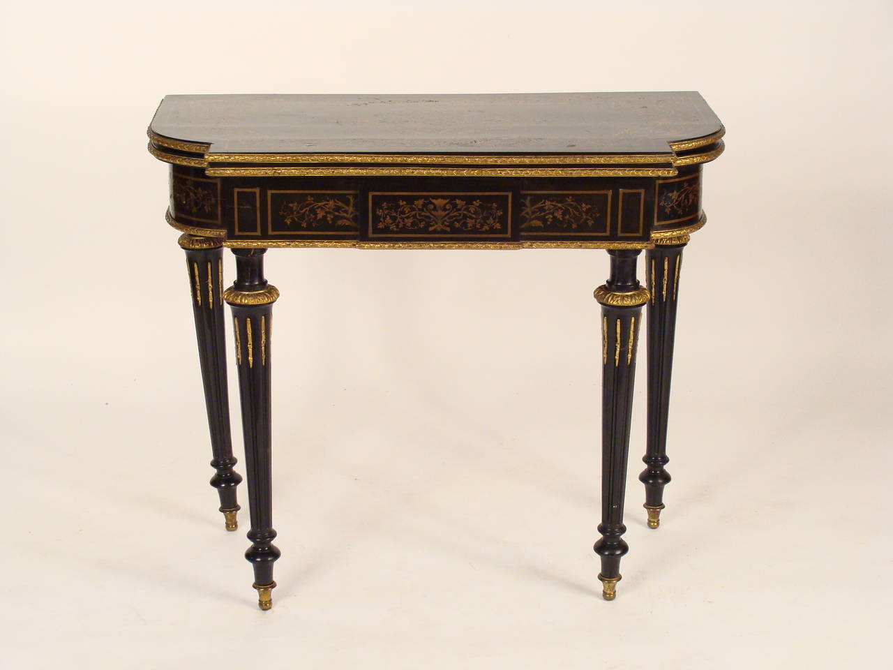Napoleon III style black lacquer games table with brass inlay and bronze mounts, circa 1920. This games table has exquisite engraved brass inlay. There is a metal label stating the table was made by Alfred Wimpen. The gaming surface measures 34.25